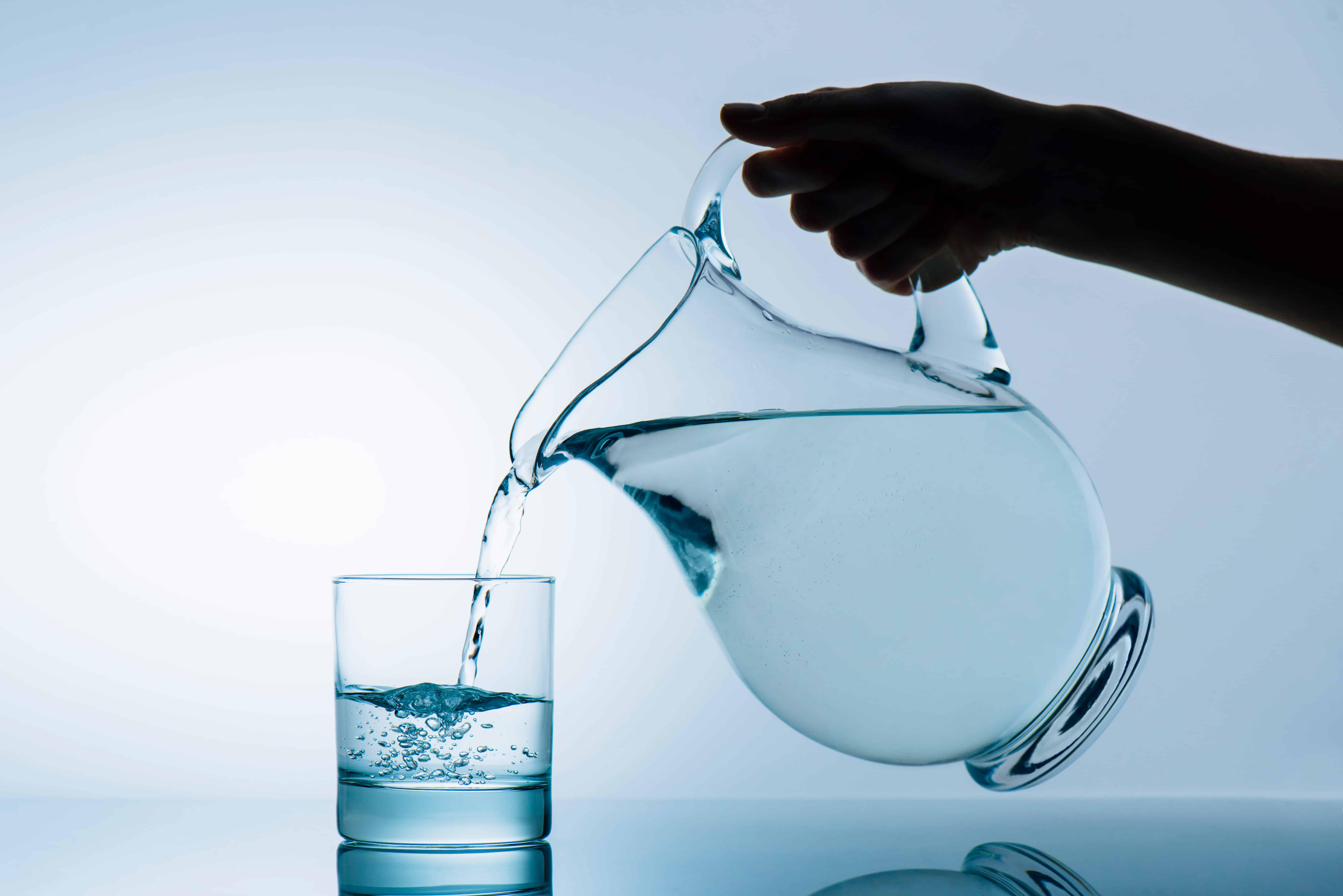 pitcher of water pouring into a glass