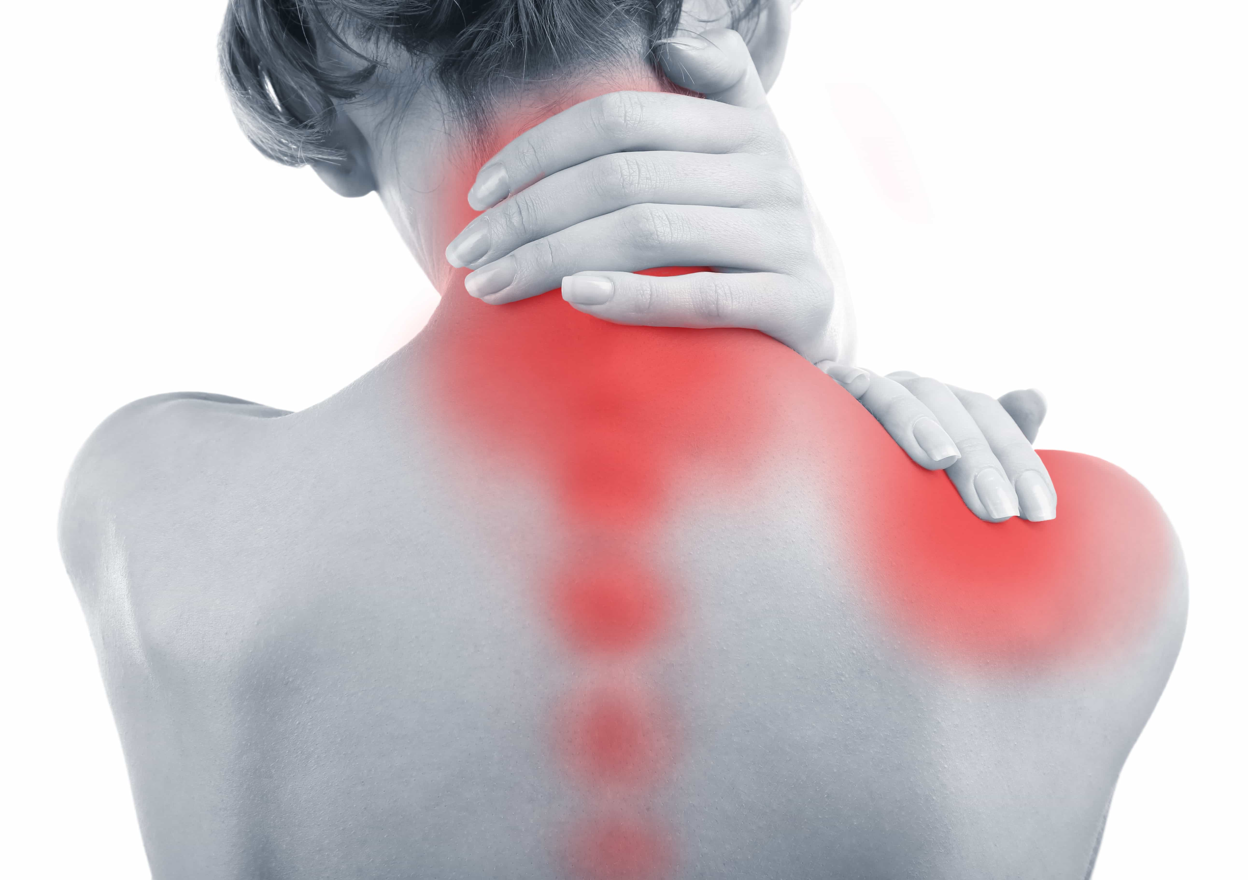 black and white image of woman holding her neck and shoulder in pain