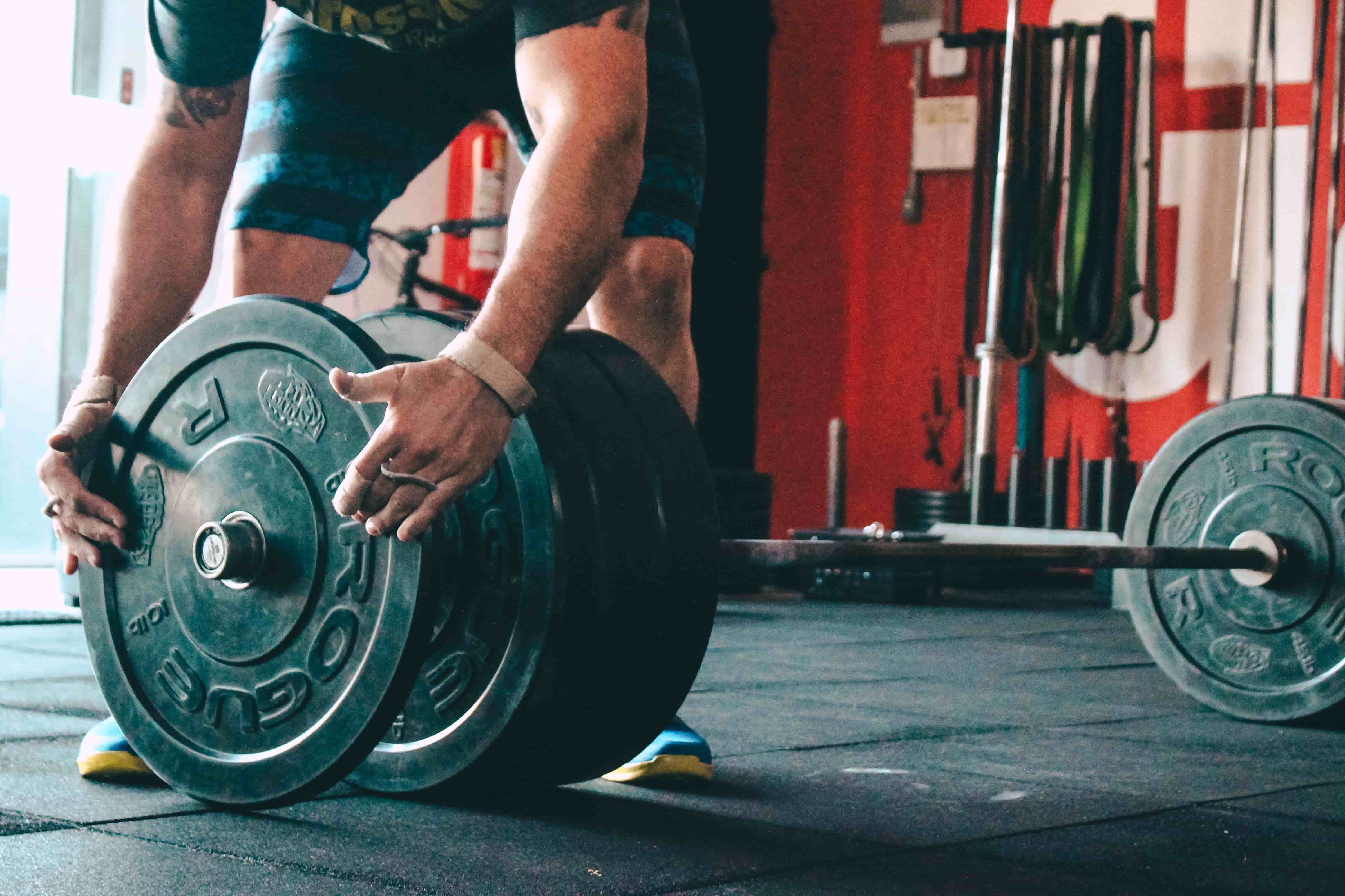 Man adding weight to a barbell